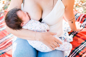 Surrogate mother breastfeeds a hungry newborn baby