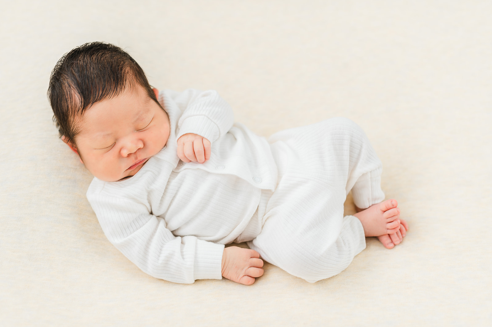 Photograph of a sleeping newborn baby boy featured in a blog article talking about Edmonton baby stores