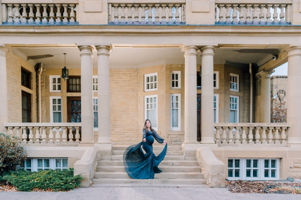 Backlit photo of an Edmonton maternity photo session at Alberta Government House with a dark grey Sew Trendy Dress