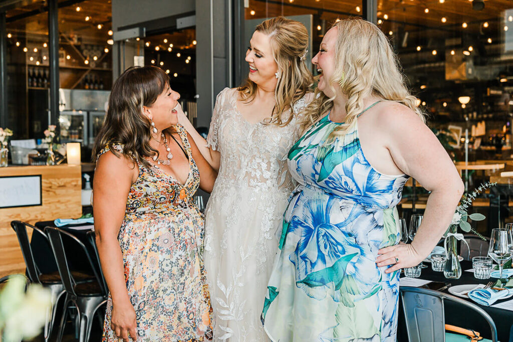 Candid moment of an Edmonton bride interacting with guests at a small Edmonton brewery wedding