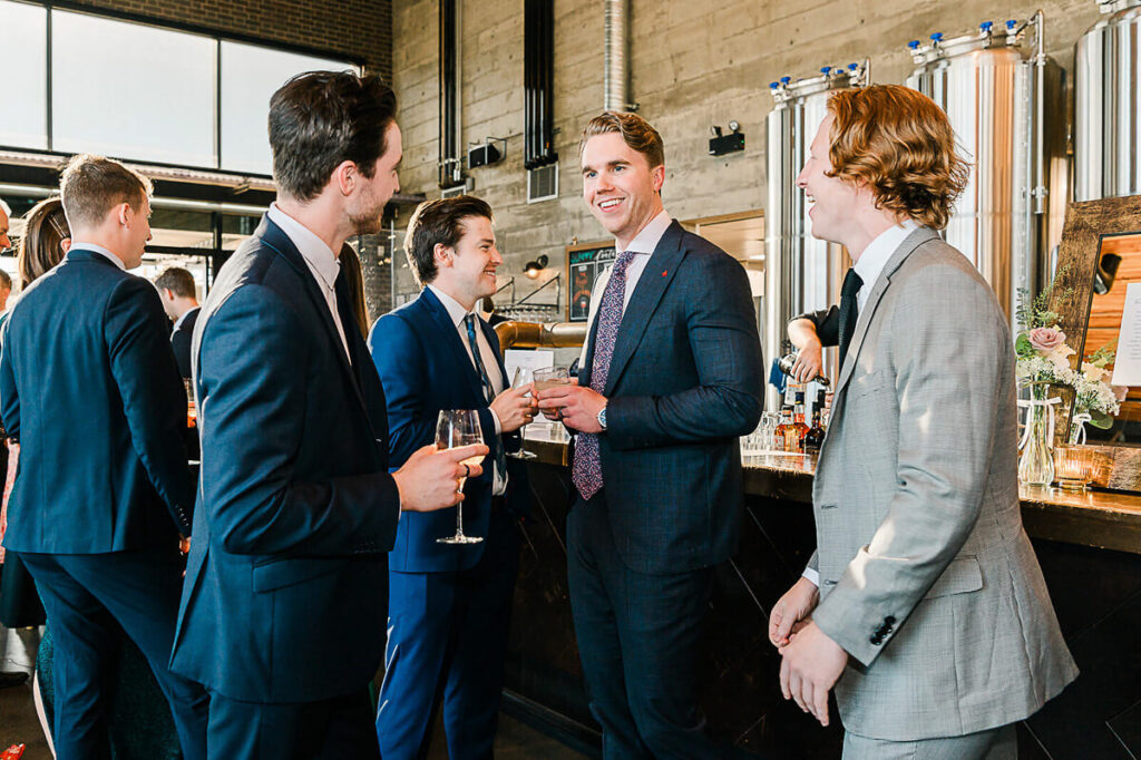 Candid capture of groom and his friends by the bar at Biera Edmonton