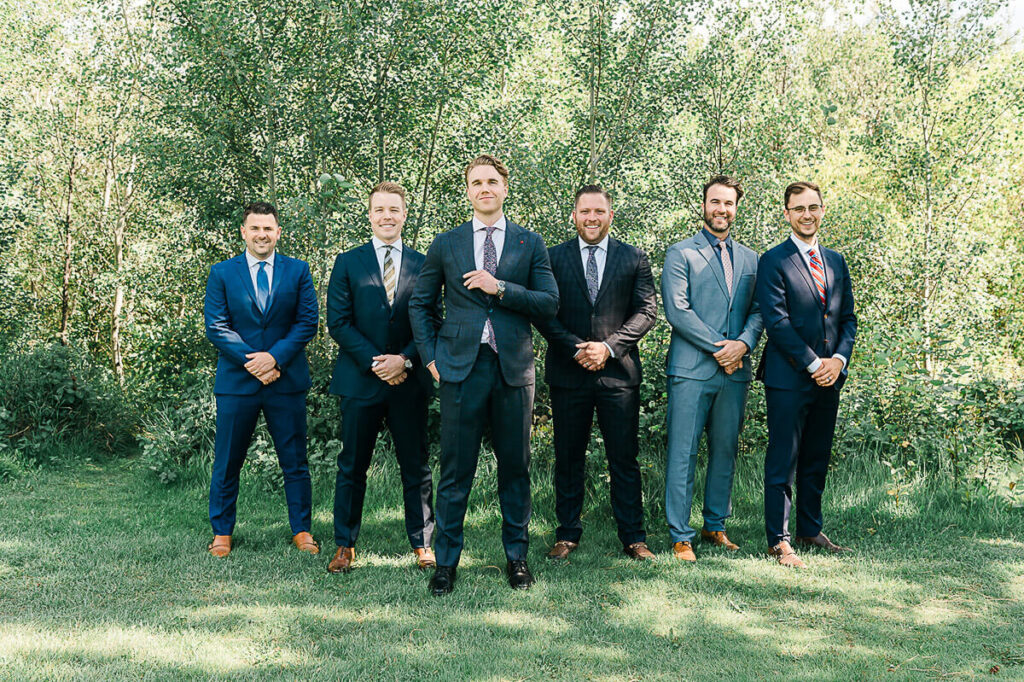 A photograph of a groom and his friends dressed in suits at Millcreek Ravine, Edmonton