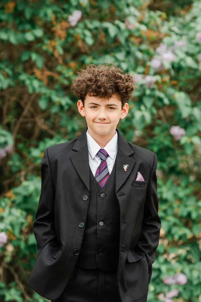Curly hair boy at his St Albert catholic church confirmation ceremony