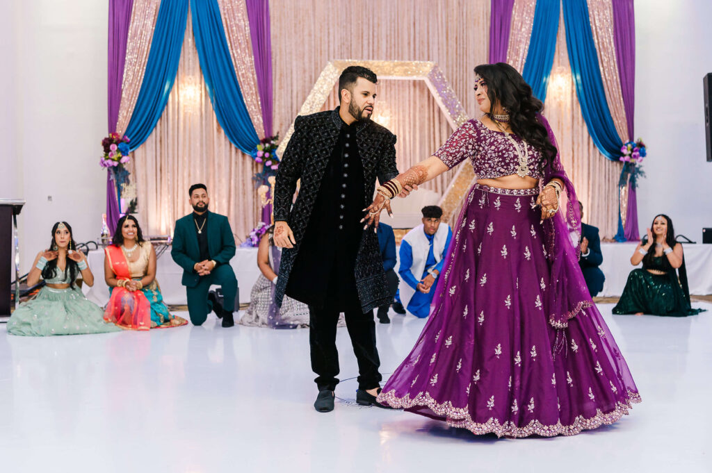 An East Indian wedding couple dancing right after their grand entrance at the Royal Palace in Edmonton, Alberta
