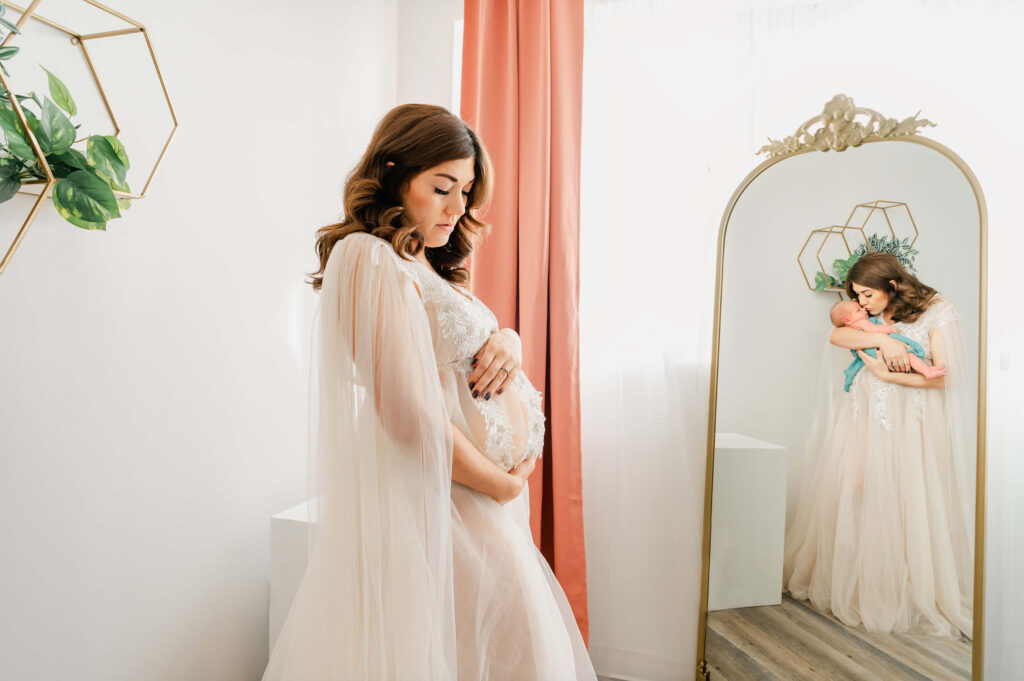 A conceptual image of pregnant Edmonton mother holds her belly while the mirror shows the future of herself holding the baby