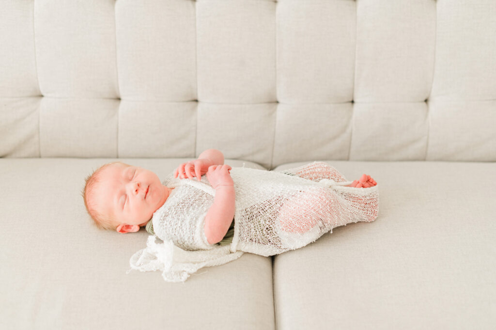 A baby swaddled in a white wrap by Cynthia Priest Photography at an Edmonton family photography studio