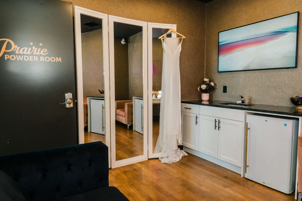 The Prairie Powder Room featuring full length mirrors and a mini bar fridge as well as a TV flat screen