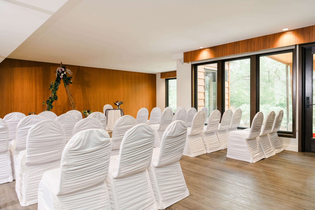 a room with white chairs and tables at a Yorath House wedding