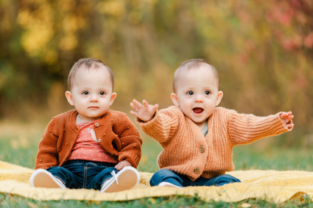 Twin baby girls having fun at an outdoor fall seession