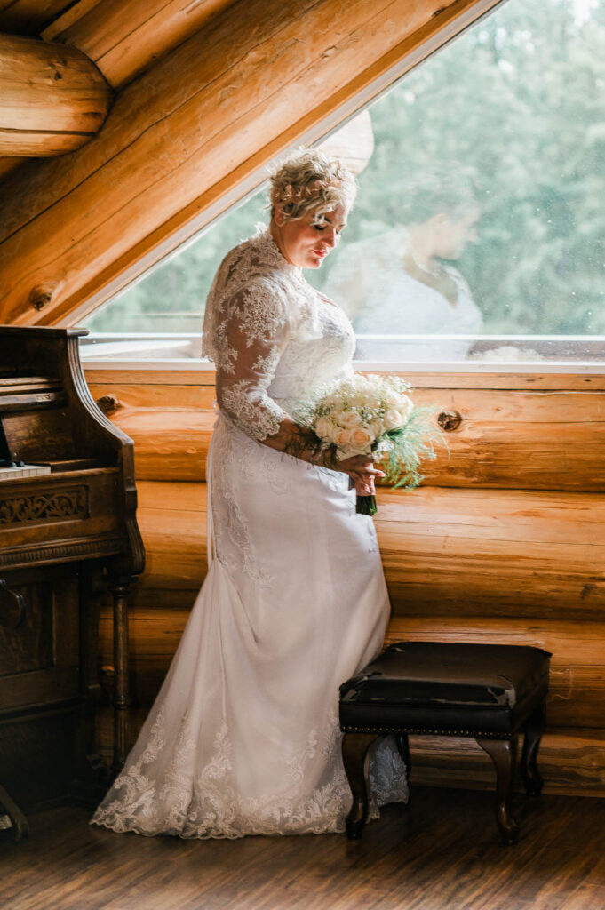 a woman in a wedding dress holding a bouquet of flowers