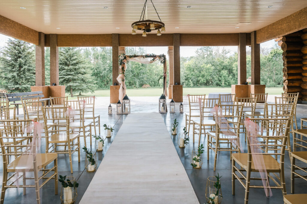 a wedding ceremony area with chairs and flowers