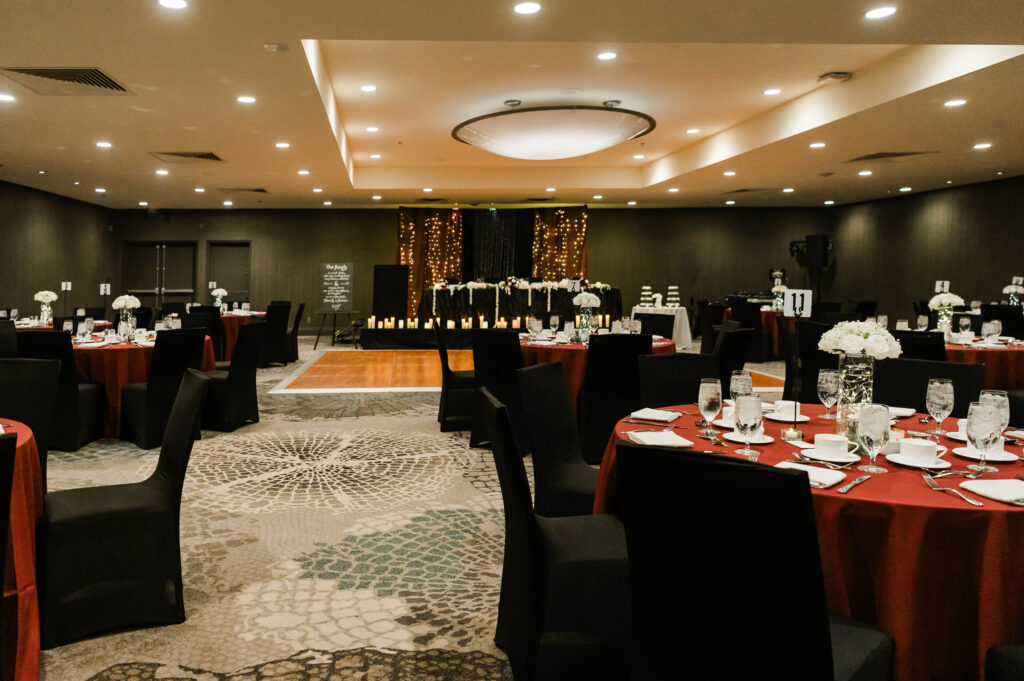 a wedding reception room with tables and chairs