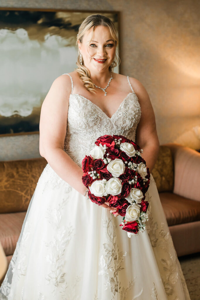 a woman in a wedding dress holding a bouquet of flowers