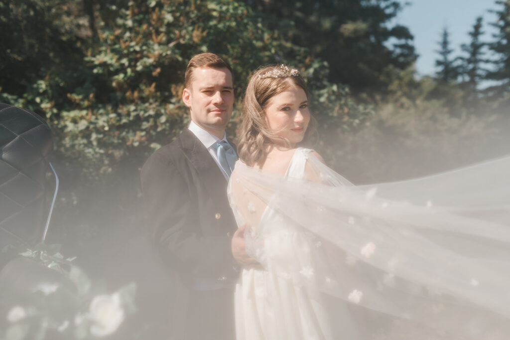 Bridgerton Inspired Ethereal Portrait of a wedding couple with capelet being photographed through by Cynthia Priest
