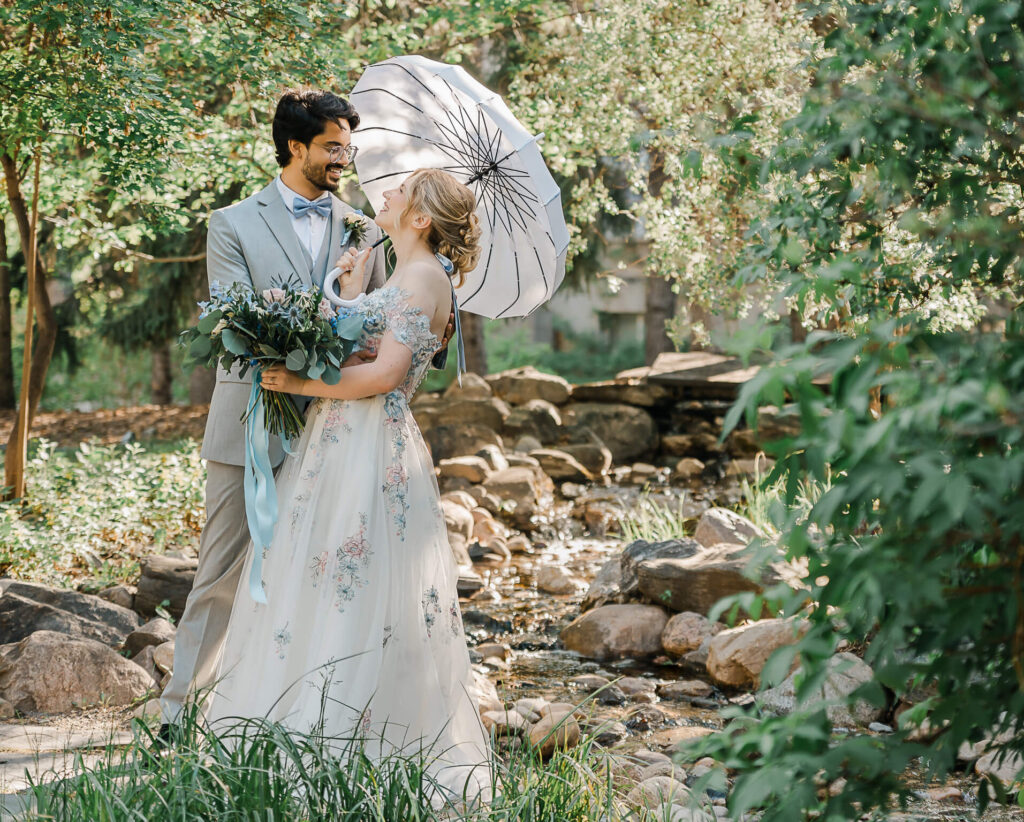 A bi-racial wedding couple during an outdoor portrait session at the University of Alberta by business quad