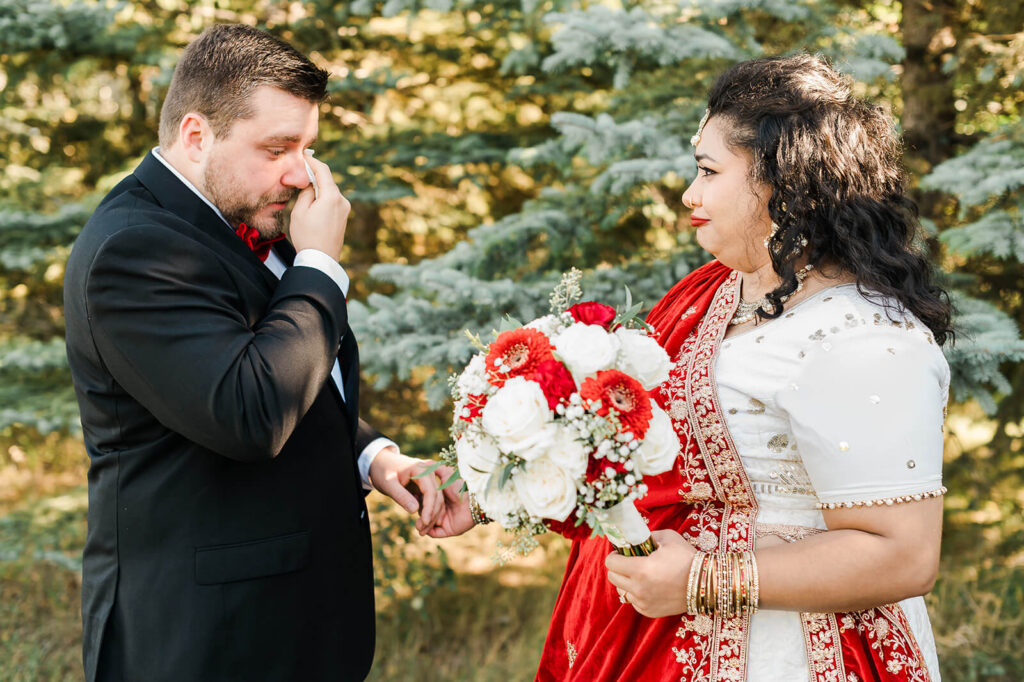 Emotional candid moment between a groom and a bride during a first look