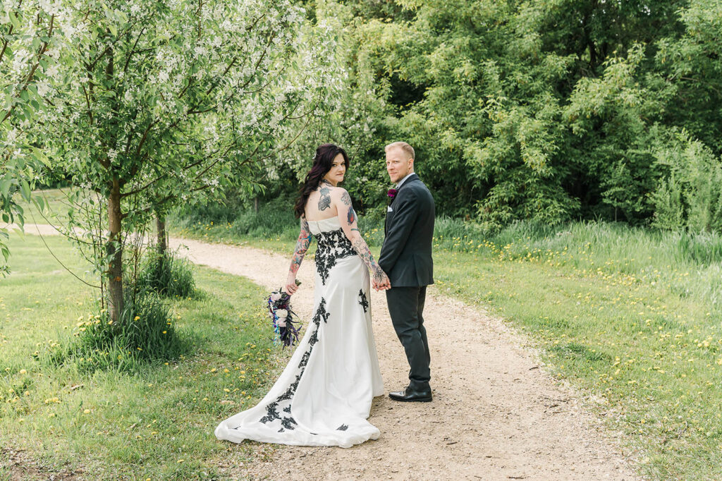 Wedding couple walking away from the camera at Yorath House, one of many beautiful Edmonton outdoor wedding venues