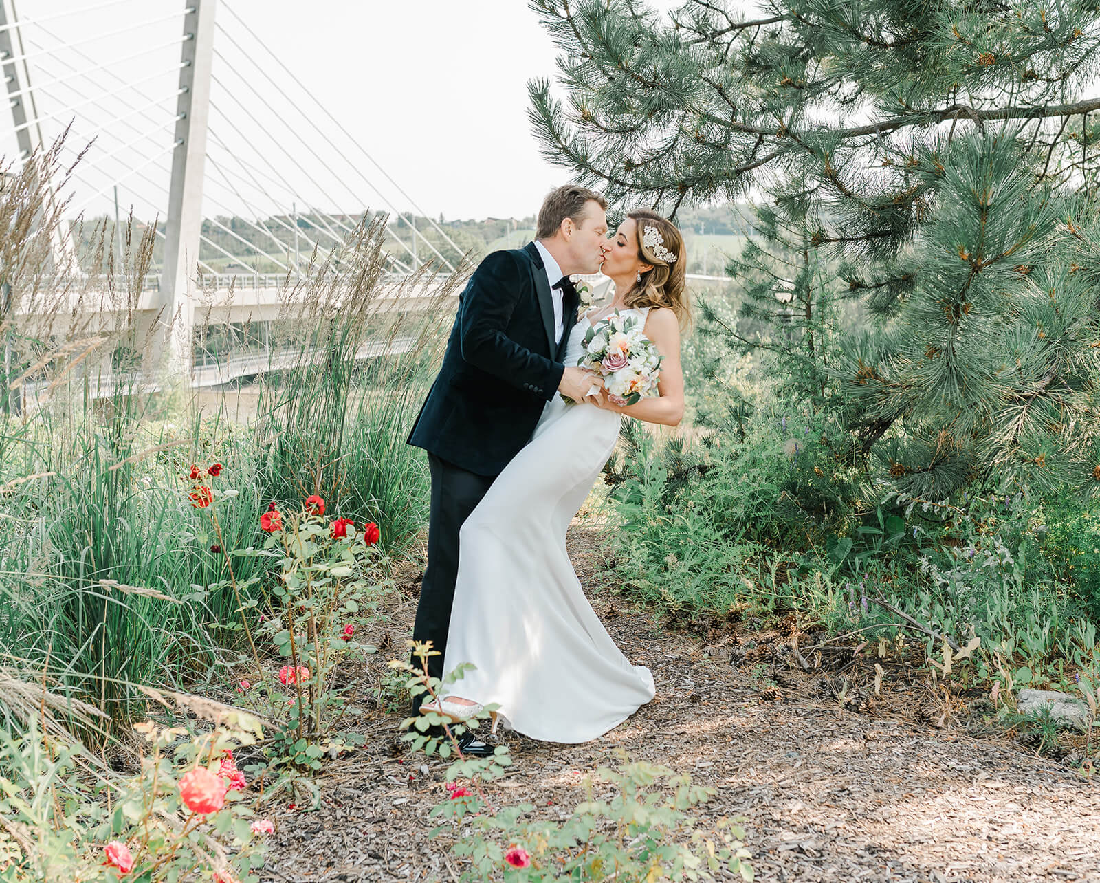 A romantic pose of a wedding couple at Louise McKinney Park, featuring a blog article on Hotel Wedding Venues Edmonton