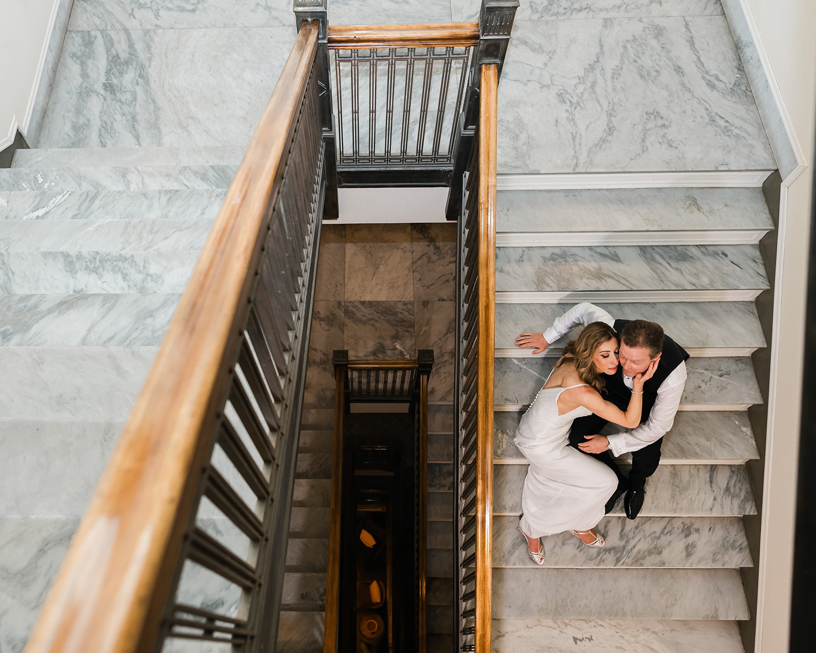 Intimate moment of Hickory and Rose's wedding clients at the marble staircase of Fairmont Hotel MacDonald